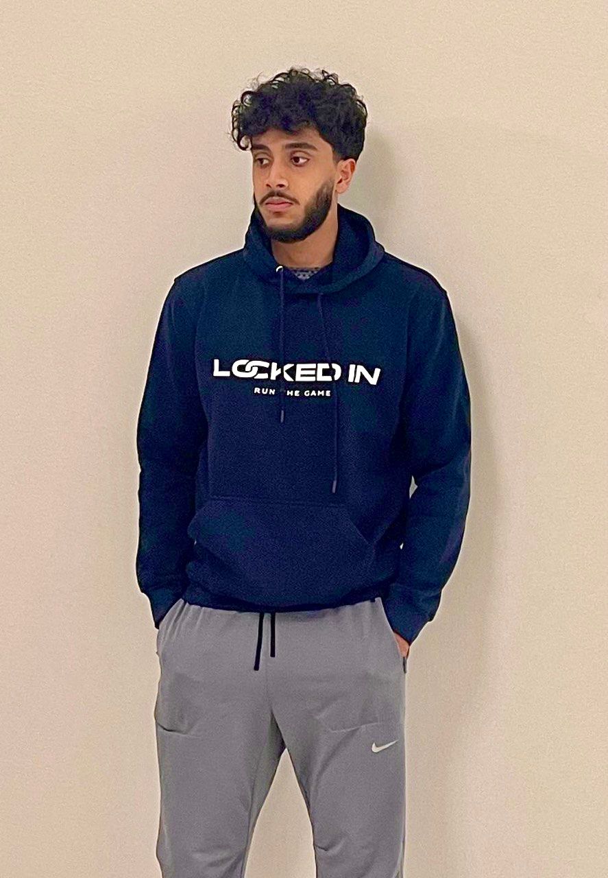 Athlete in a LockedIn hoodie holding a basketball