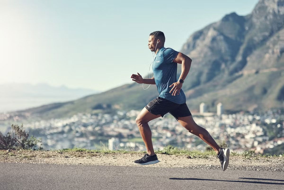 Runner training on a mountain road